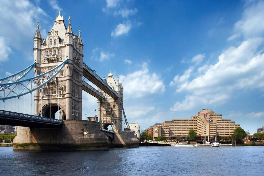 London's Tower Bridge over the River Thames with The Tower Hotel in the background, a key landmark and accessible accommodation for accessible travel in London.