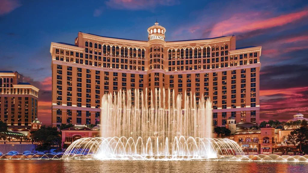 The Bellagio Hotel & Casino in Las Vegas at sunset, with its famous fountains, symbolizing an accessible travel destination.