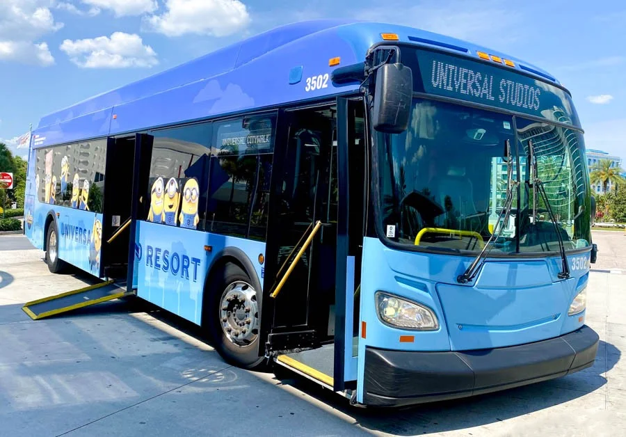A Universal Orlando Resort bus with its wheelchair ramp extended, demonstrating the accessible transportation for accessible travel in Orlando.